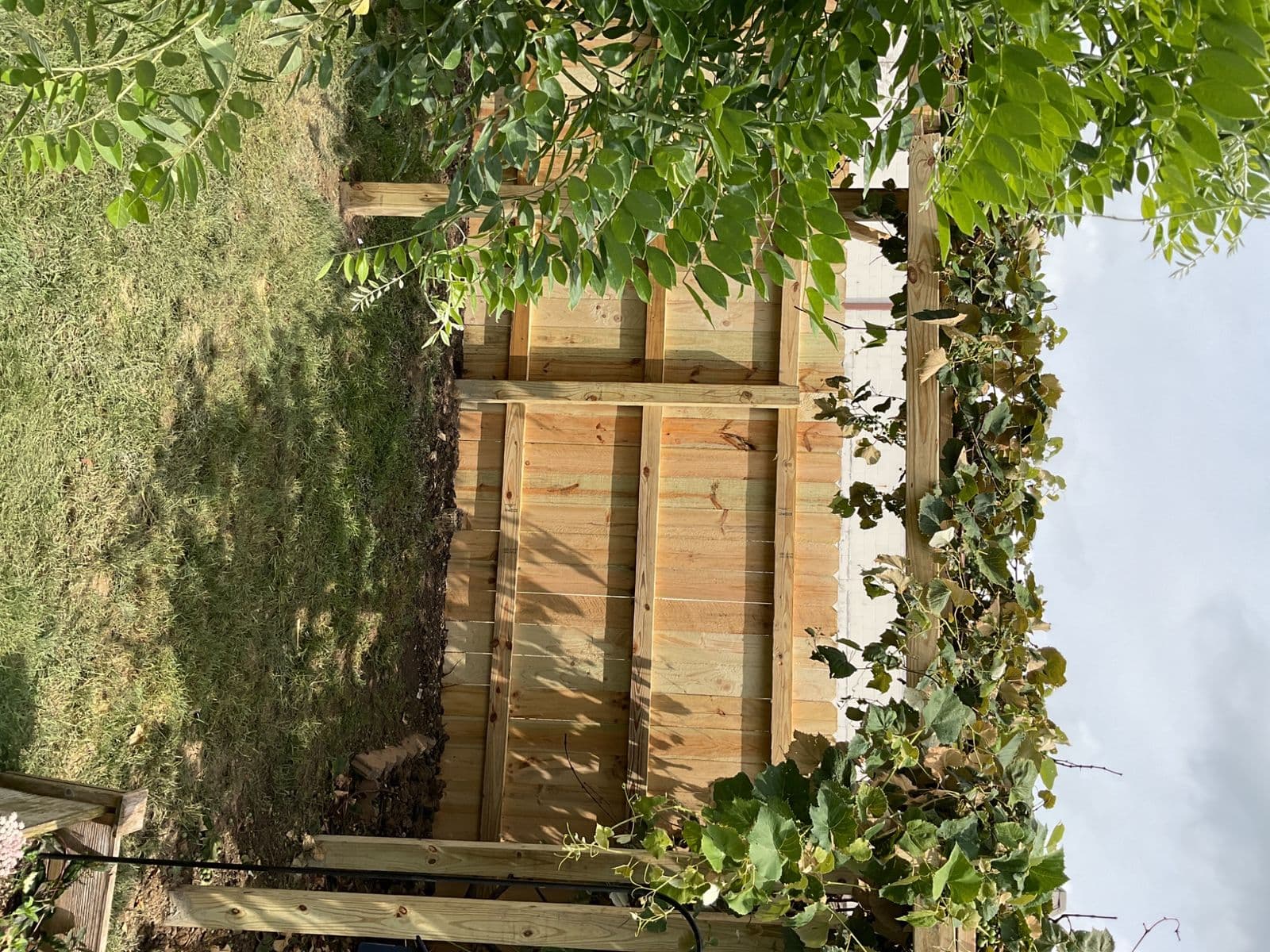 New wood privacy gate with horizontal cedar boards between two posts